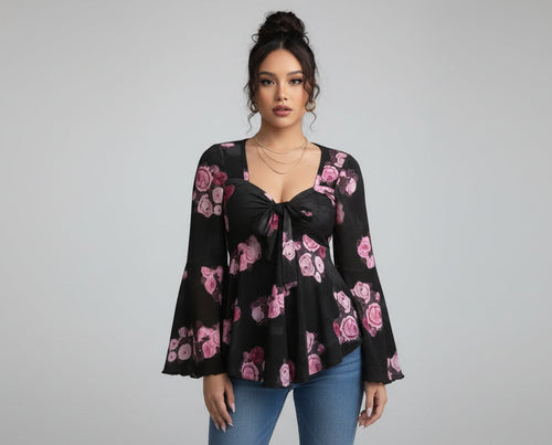 Woman wearing a black floral blouse taking a mirror selfie.