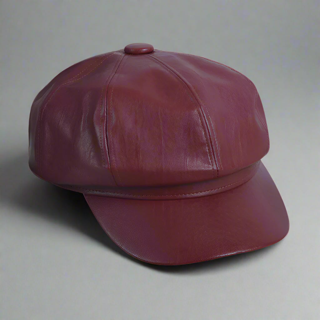 Maroon leather cap on a white background