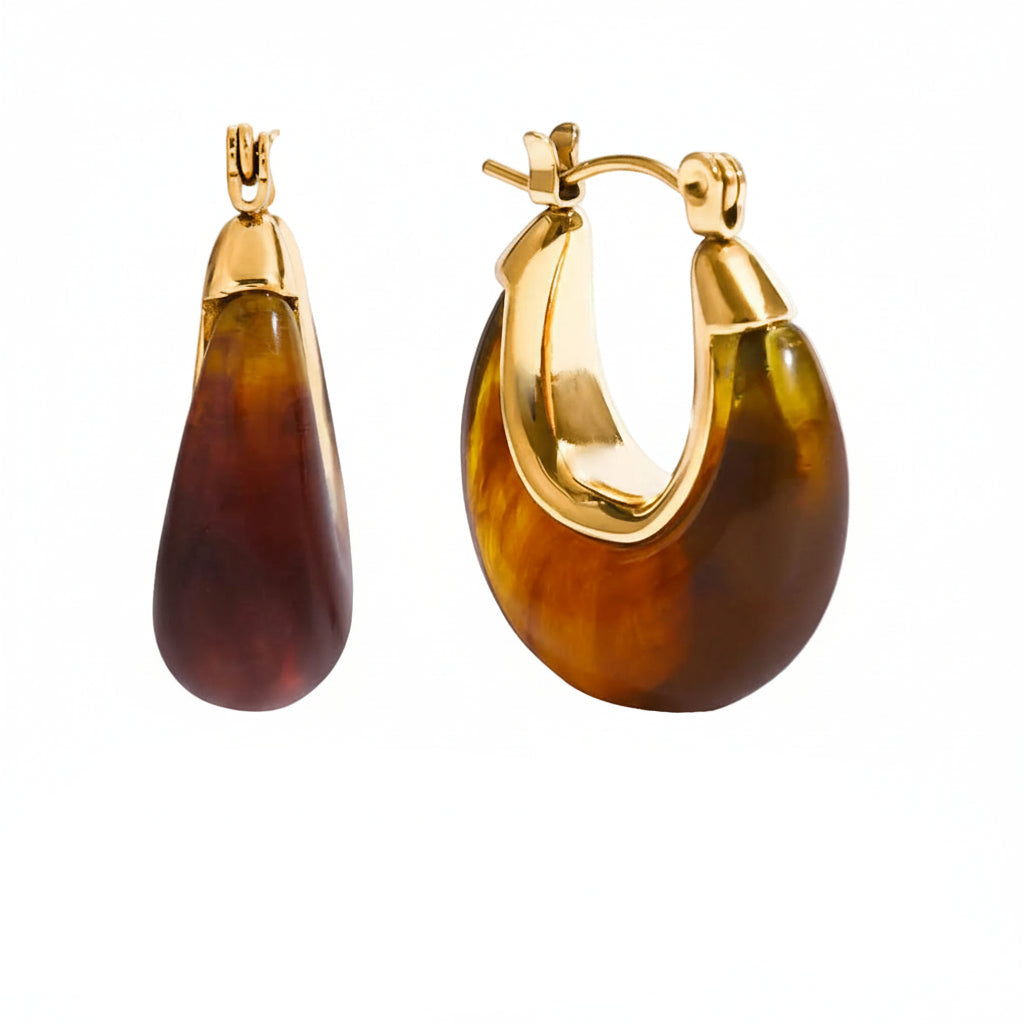 Gold and tortoiseshell earrings with measurements and product details on a white background