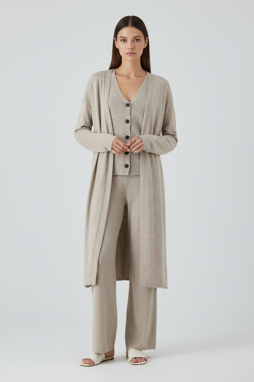 Beige cardigan, shirt, and pants set on a white background
