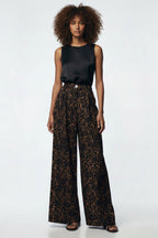 Leopard print wide-leg pants worn by a person on a white background