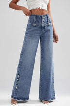 Person wearing wide-leg jeans on a city street.