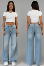 A model shown from the front and back wearing light-wash wide-leg jeans and a white cropped short-sleeve t-shirt against a solid gray studio background.