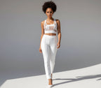 Woman wearing a white outfit against a gray background
