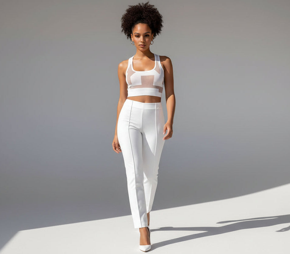 Woman wearing a white outfit against a gray background