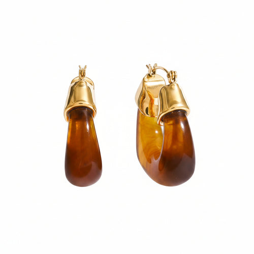 Pair of amber hoop earrings with gold tops on a white background