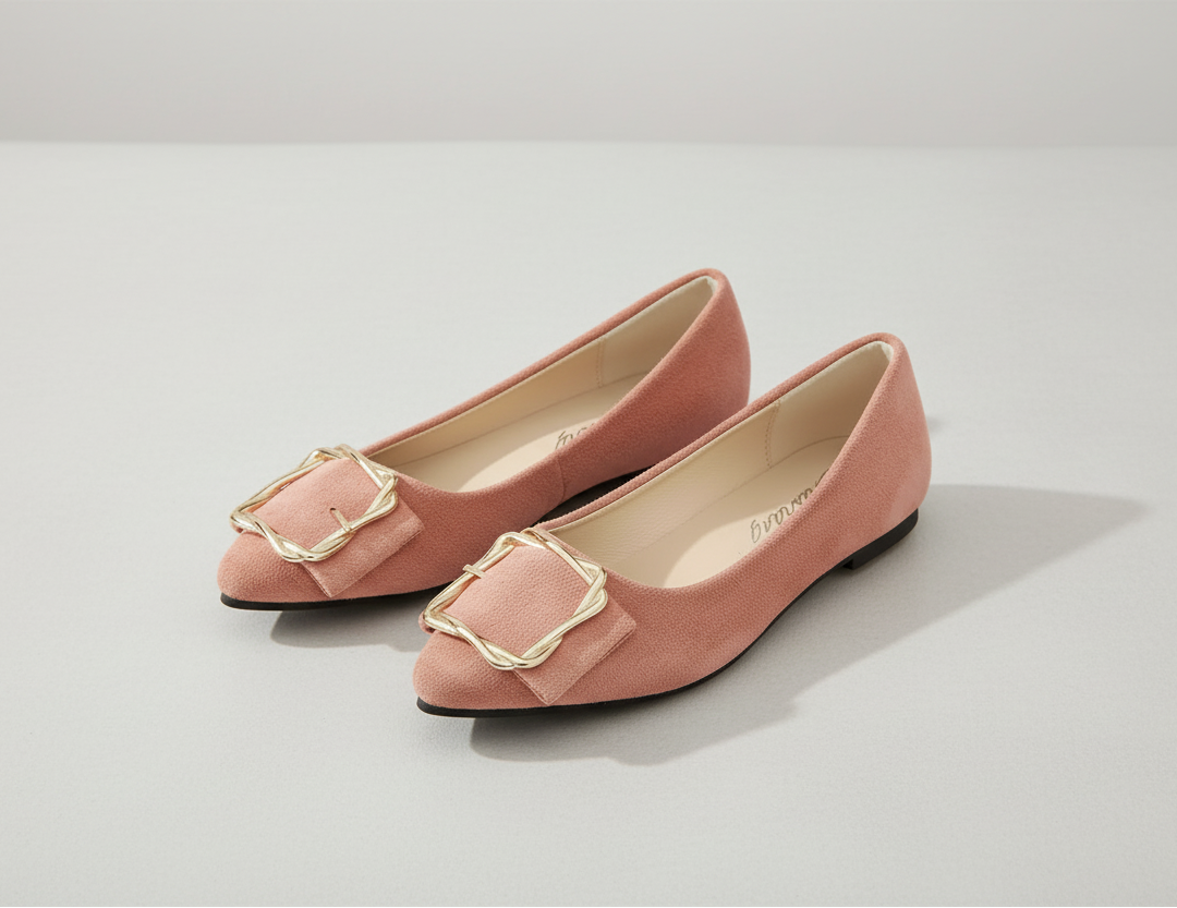 Pair of pink shoes with gold buckles on a white background
