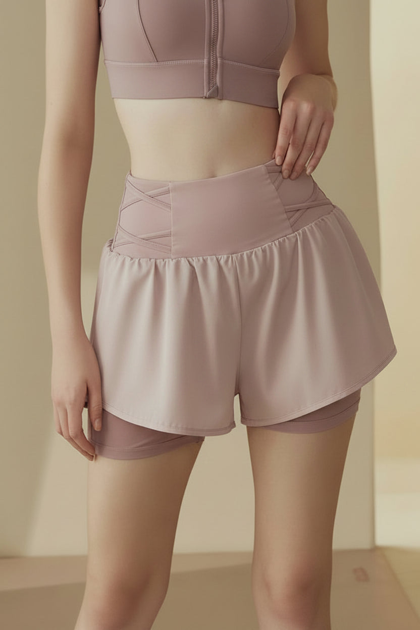 Person wearing a matching pink crop top and shorts set on a neutral background