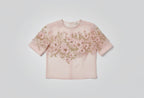Pink blouse with floral embroidery on a blurred background