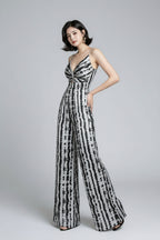 Woman wearing a black and white patterned dress on a gray background