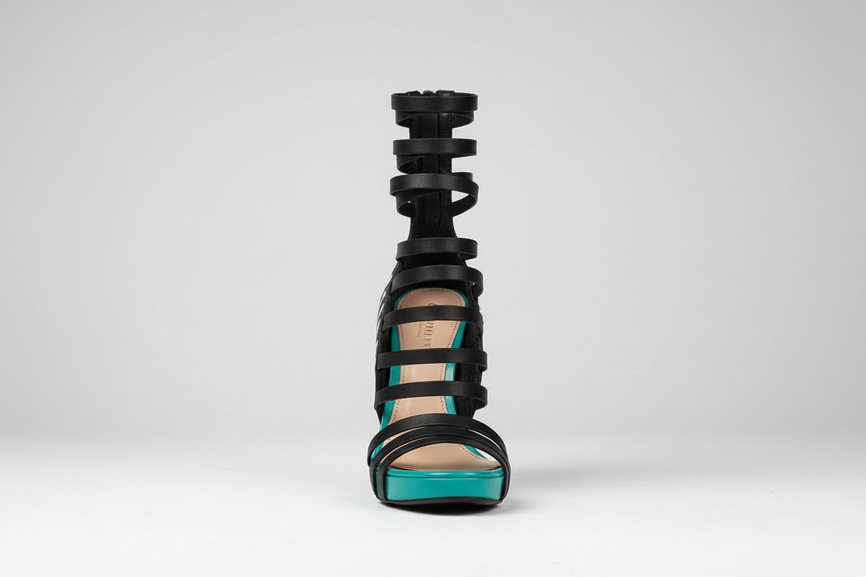 Black strappy high-heeled sandal with zebra pattern on a white background