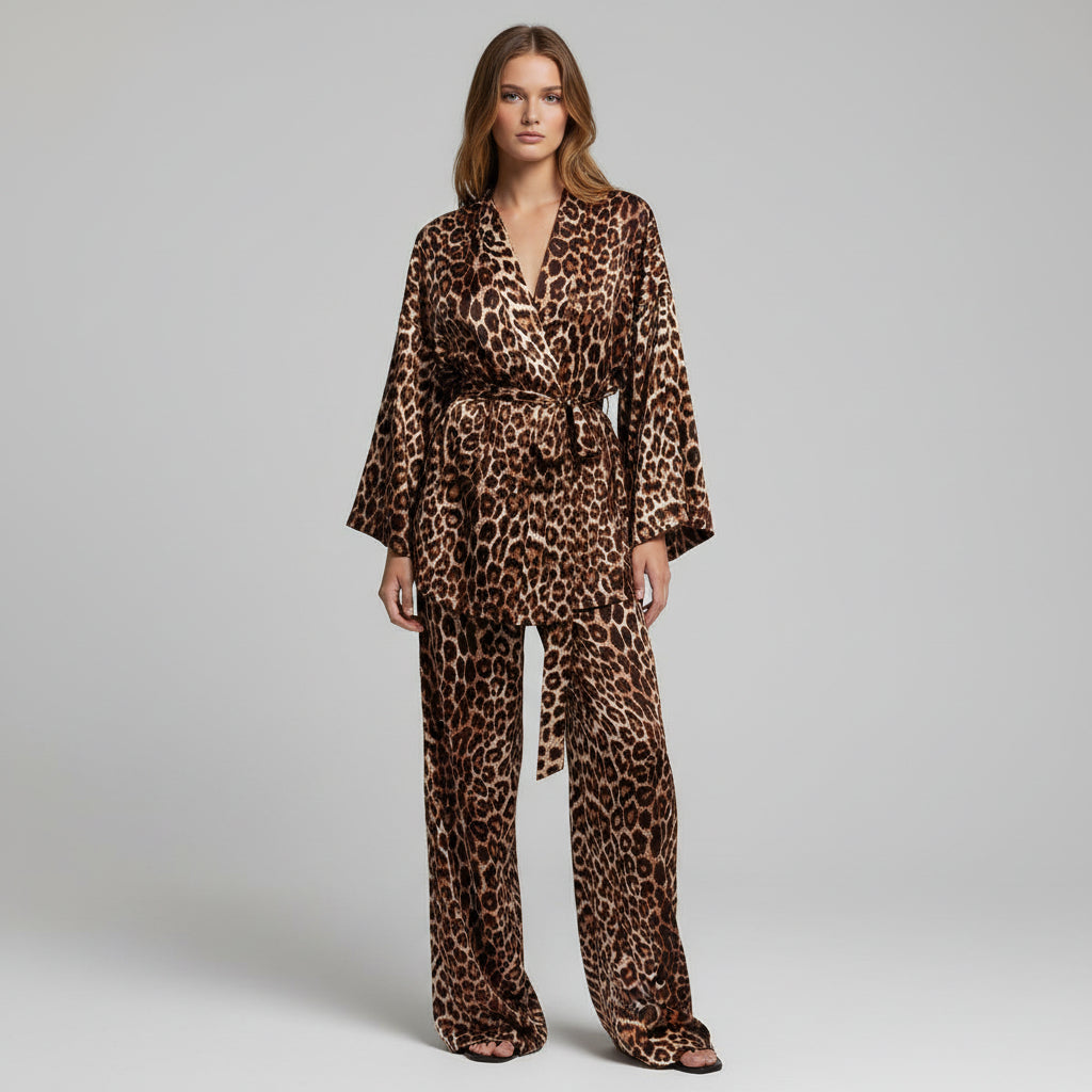 Woman in leopard print outfit standing in front of a black door.