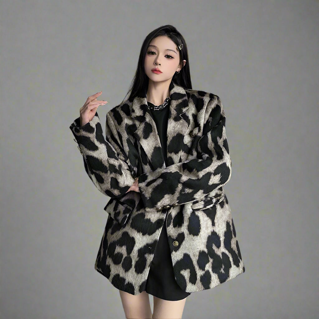 Woman wearing a leopard print coat in an indoor setting