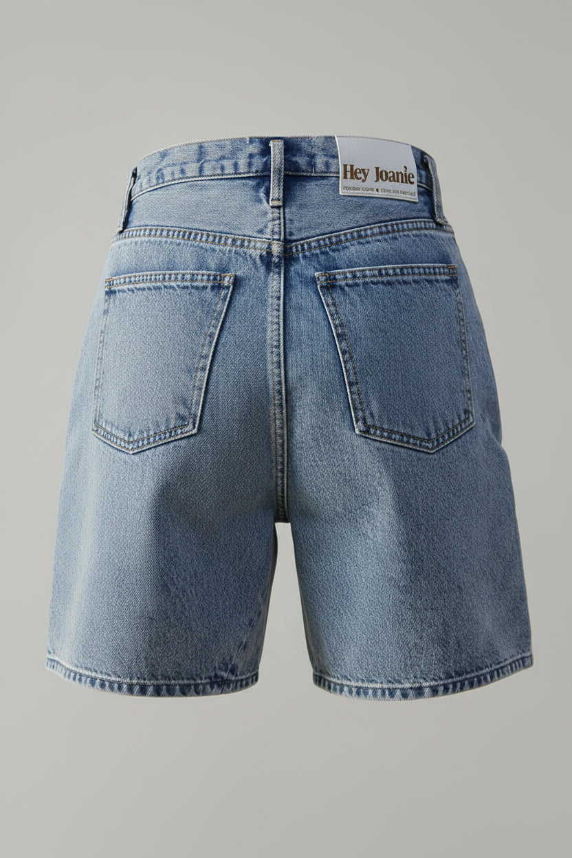 Blue denim shorts with a brand label on a beige background