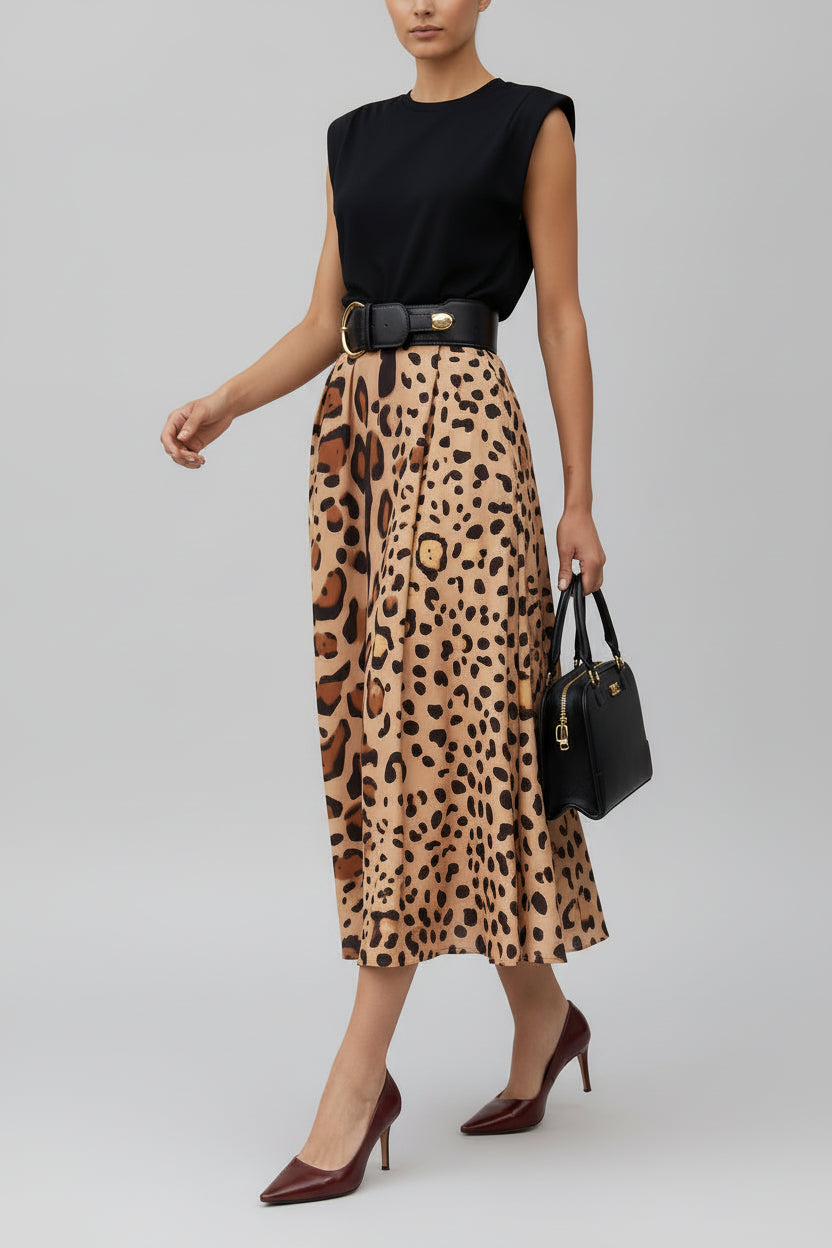 A person wearing a leopard print, big hem skirt with a black top, Accessories such as a belt, handbag, and shoes are also visible.