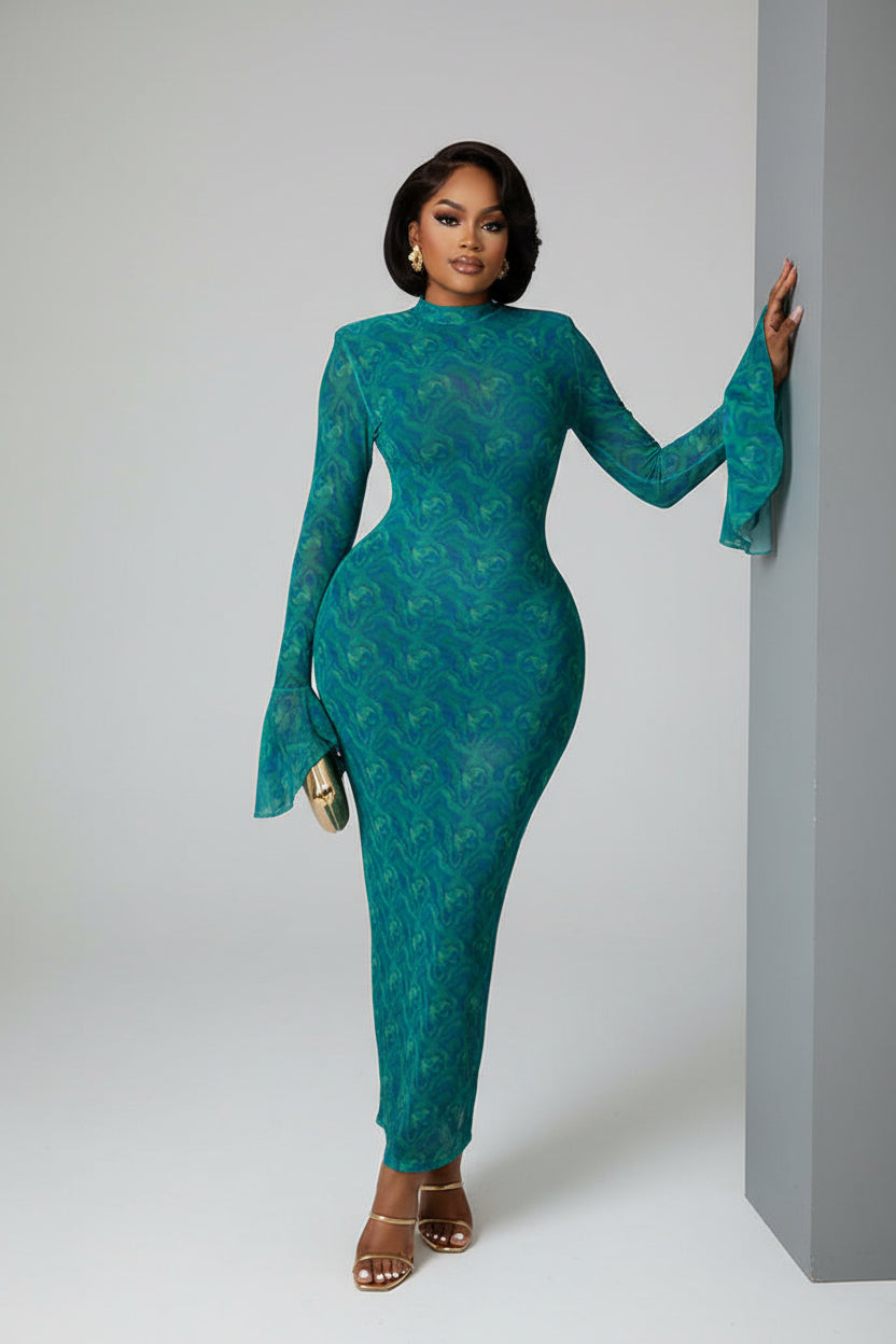 Woman in a teal dress standing in a modern interior setting