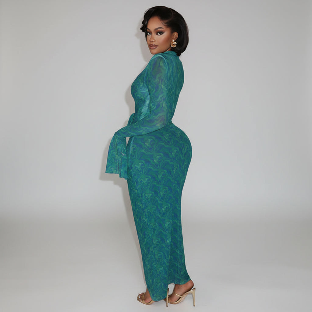 Woman in a teal dress sitting on a staircase