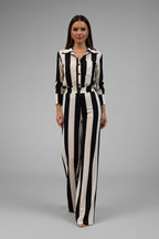 Woman wearing a black and white striped outfit on a gray background