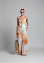 Woman wearing a tie-dye dress with a white background