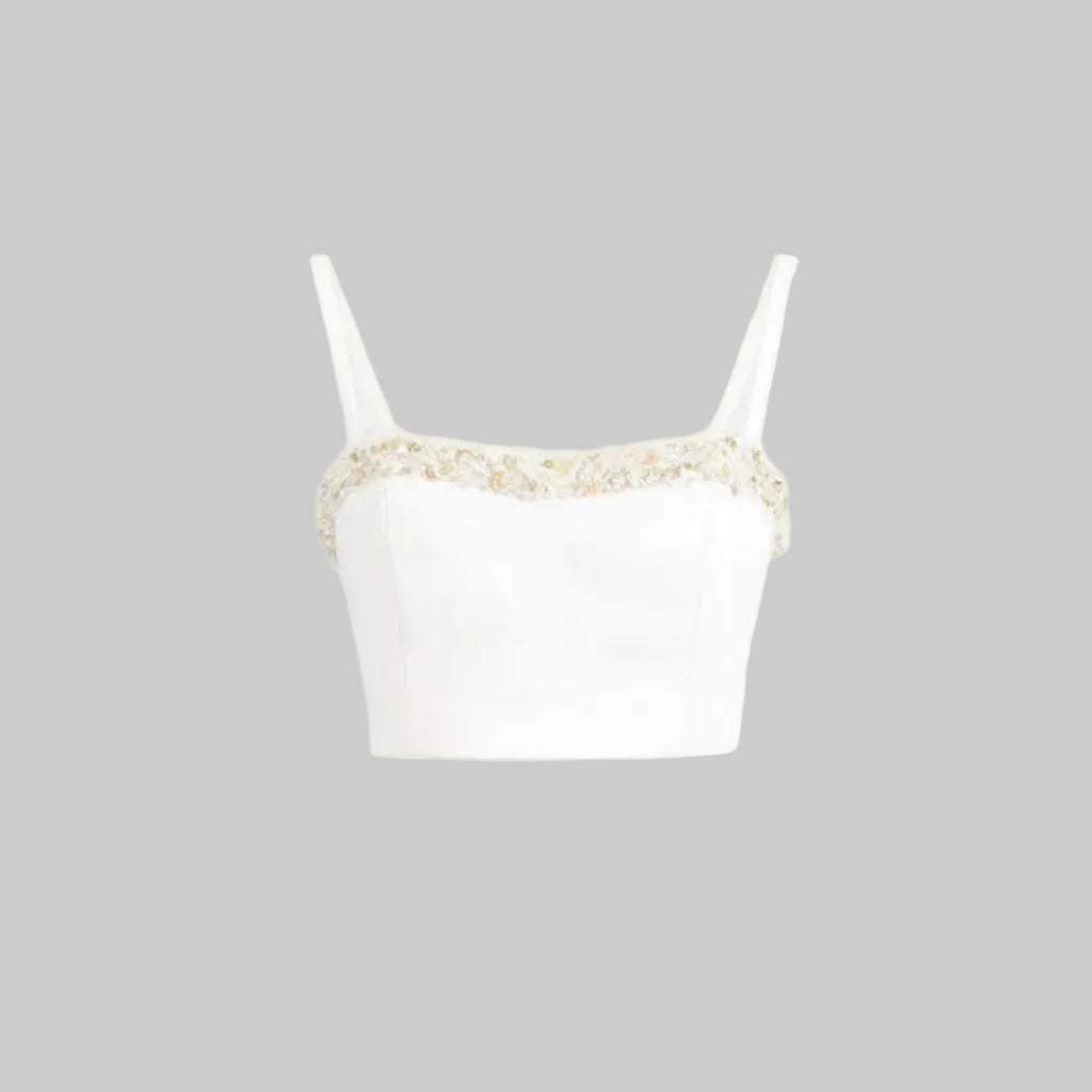 White top with gold lace trim on a white background