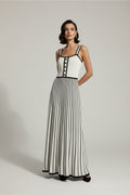White dress with black stripes and buttons on a hanger against a white background