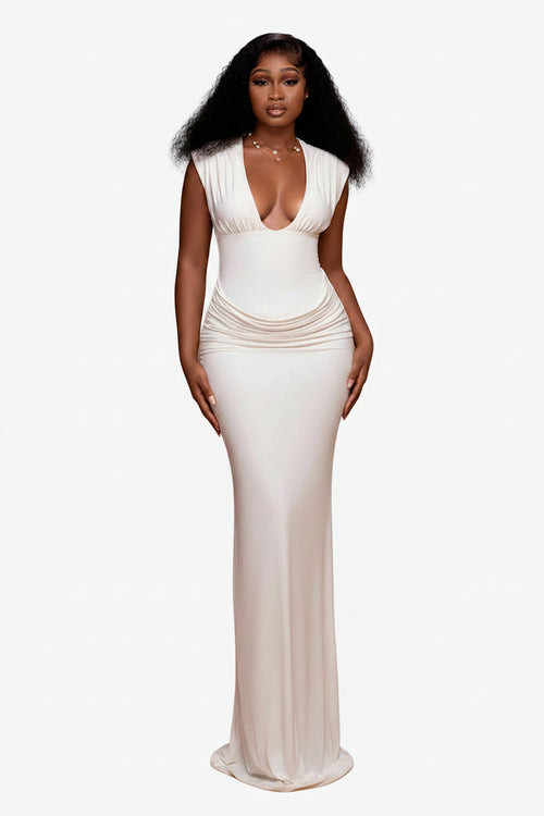 Woman wearing a white evening gown against a brown background