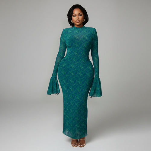 Woman in a teal dress standing in an elegant interior setting