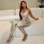 Woman sitting on a couch wearing a patterned outfit.