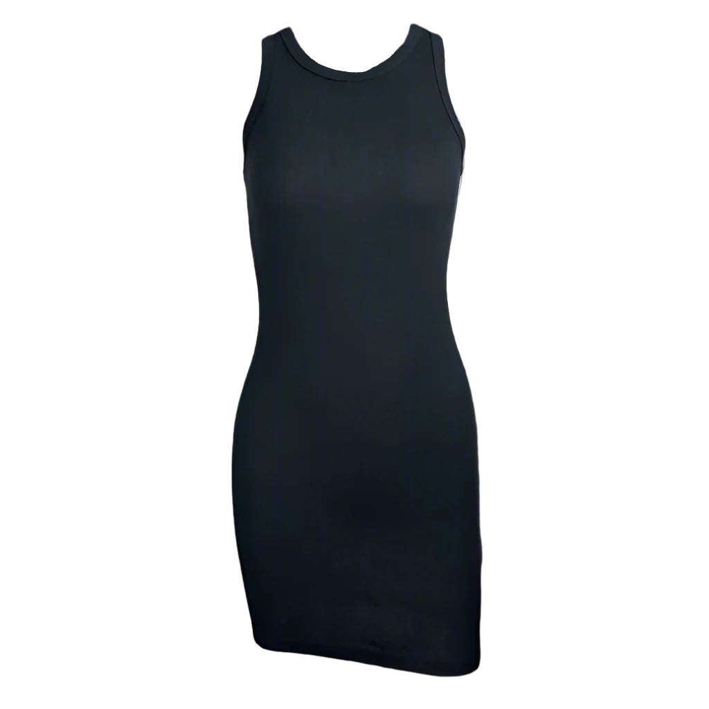 A woman wearing a white sleeveless mini dress with a crew neckline, posing against a concrete background.