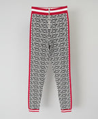 Black and white geometric patterned pants with red accents on a white background