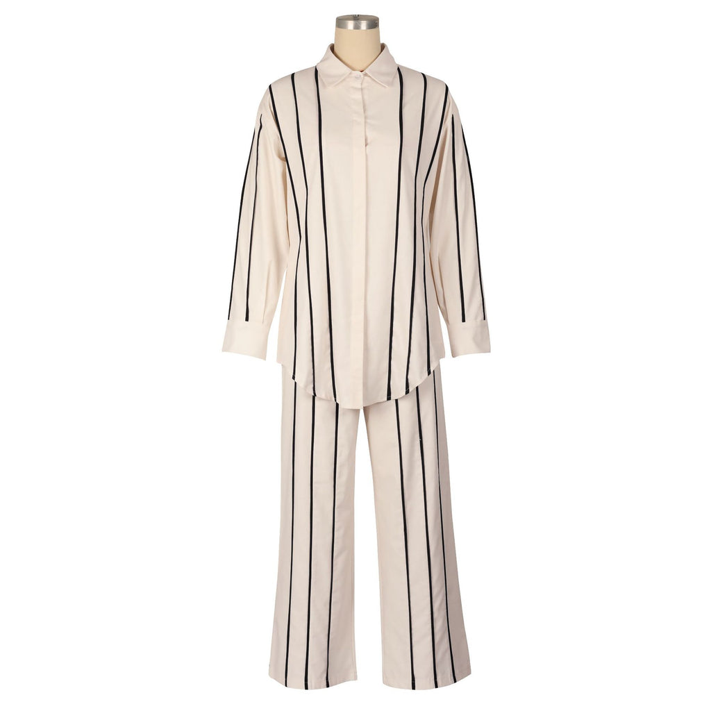 Mannequin wearing a beige and black striped outfit on a white background