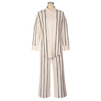 Mannequin wearing a beige and black striped outfit on a white background
