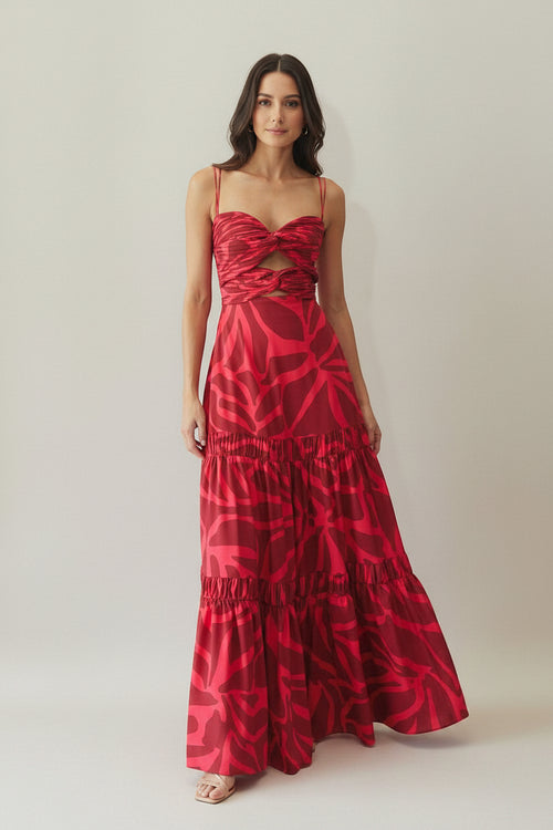 Red patterned dress worn by a model on a plain background
