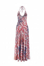 Red and white patterned dress on a mannequin against a white background