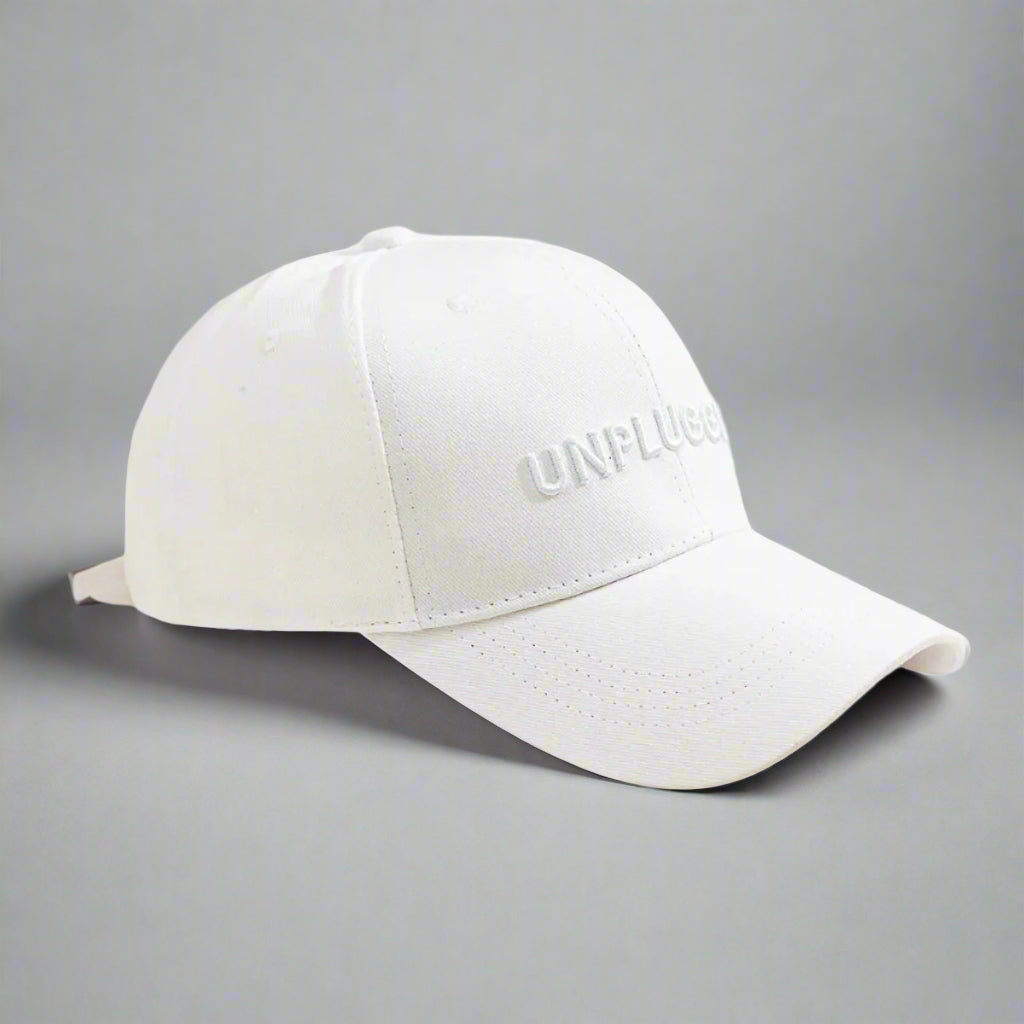 White cap with 'UNFLUG' branding on a white background