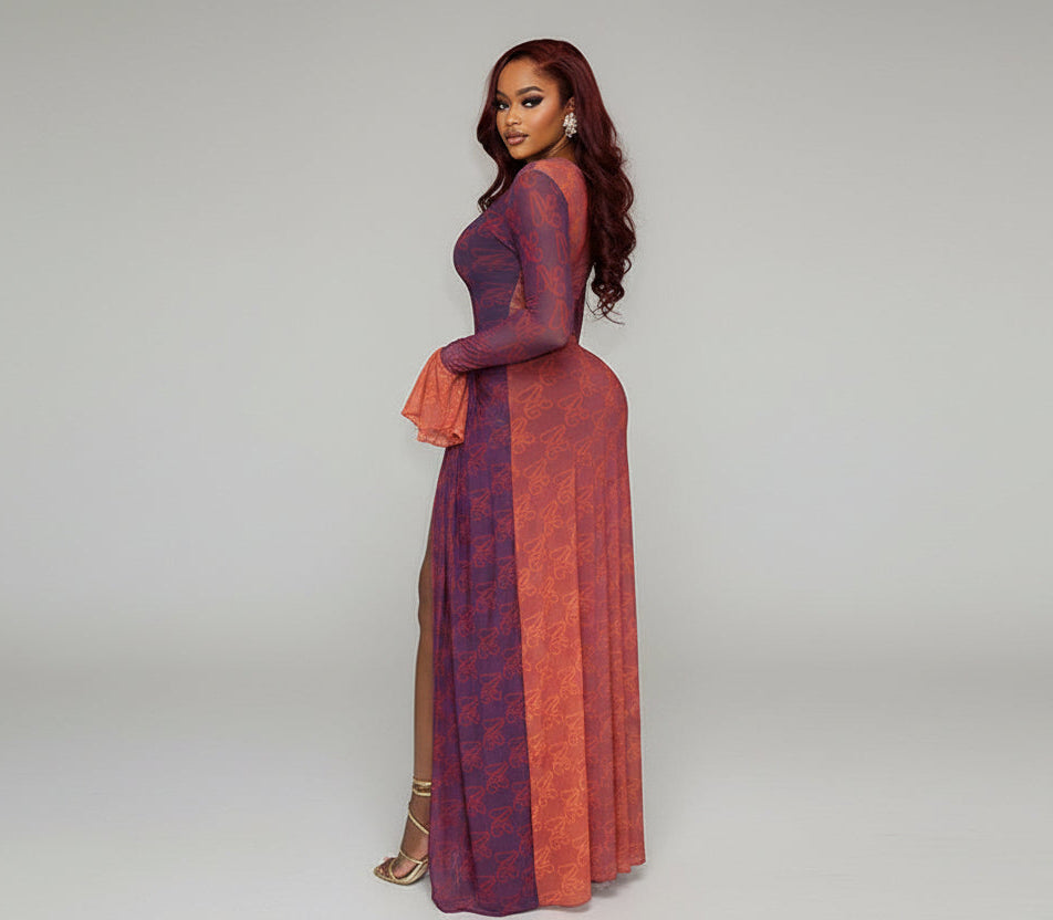 Woman in a two-tone dress standing on a staircase in an indoor setting