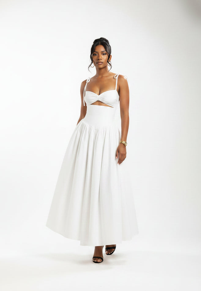 Woman wearing a white dress with cut-out design against a brown background
