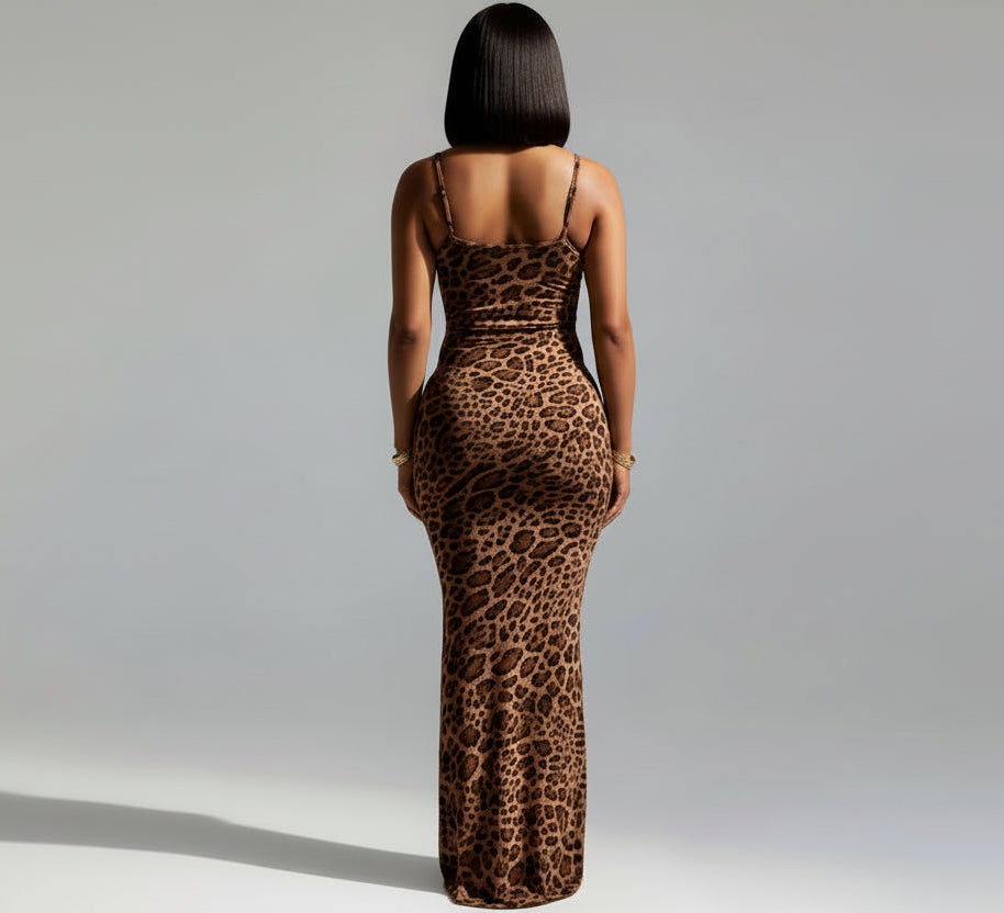 Woman wearing a leopard print dress against a white wall