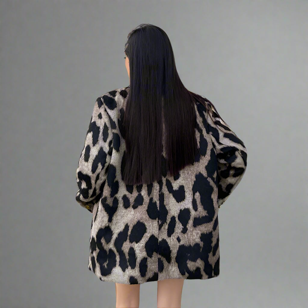 Person wearing a leopard print coat in an indoor setting