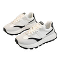 White sneakers with black accents on a gray surface
