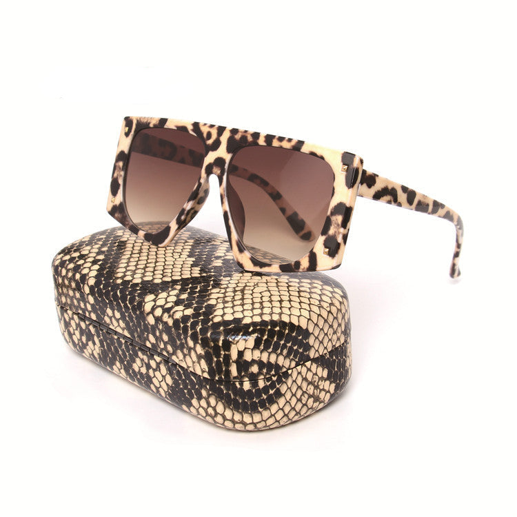 A pair of square-framed sunglasses with leopard print pattern, displayed above a matching textured case.