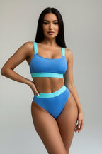 Person wearing a blue bikini set with a neutral background